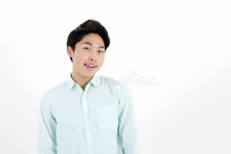 hungry-asian-male-student-licking-his-lips-51062168.webp