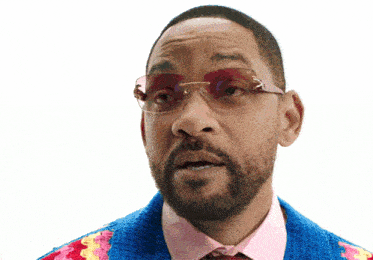 a man wearing sunglasses and a colorful sweater