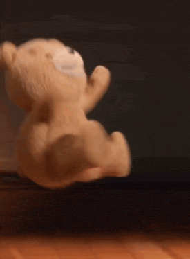 a teddy bear is jumping in the air .