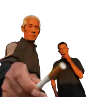 a man smoking a cigarette while another man holds a cigarette