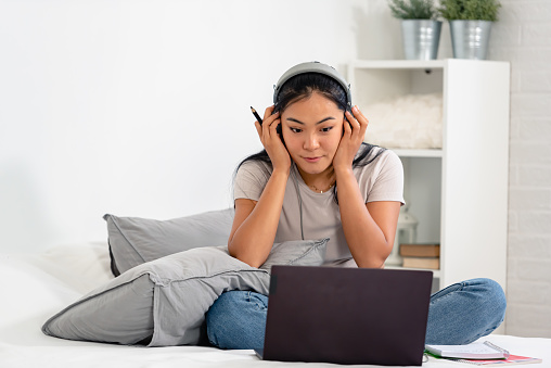 asian-student-a-young-woman-learning-the-english-language-over-the-internet-at-home.jpg