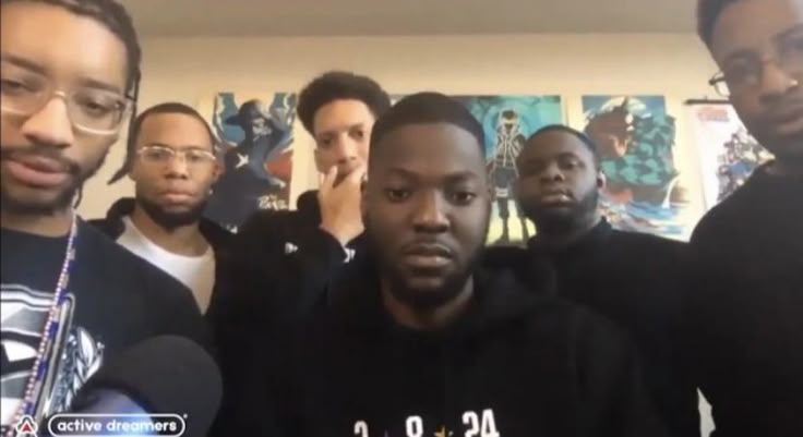This may contain: a group of men standing next to each other
