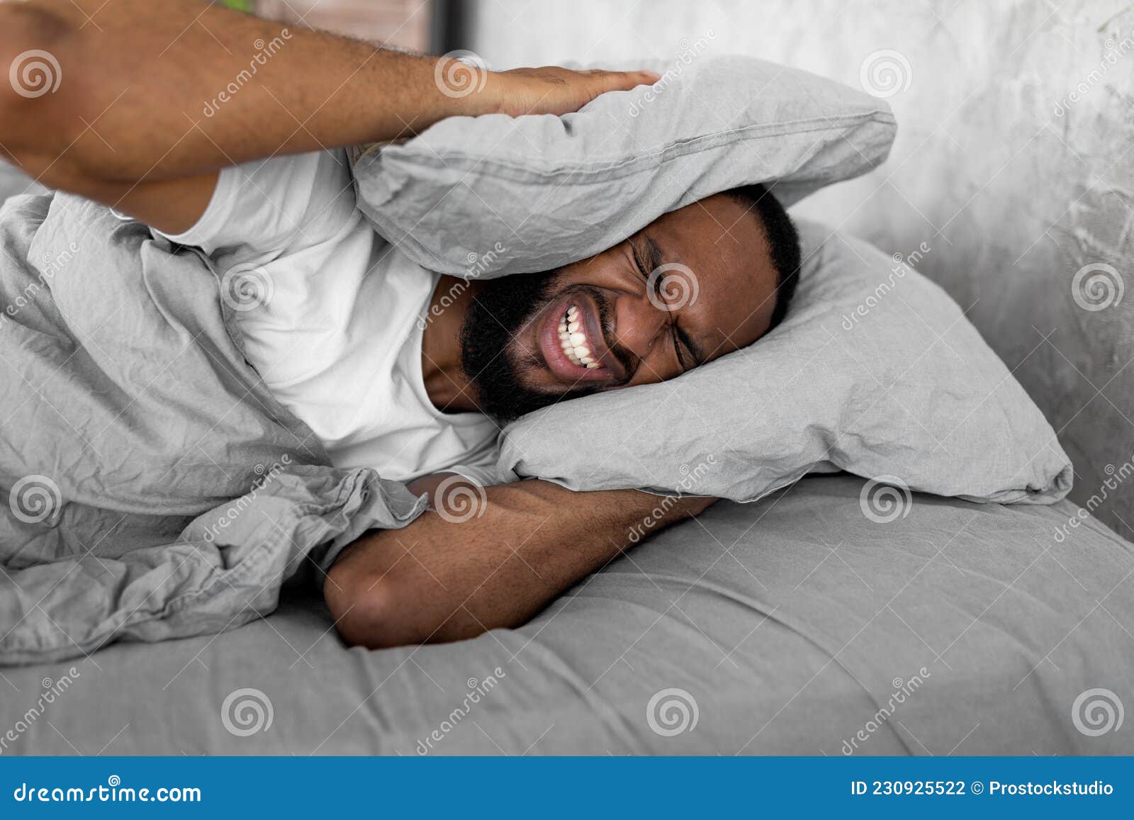 stressed-black-man-covering-ears-lying-bed-i-can-t-sleep-portrait-irritated-young-black-man-lying-bed-covering-ears-230925522.jpg