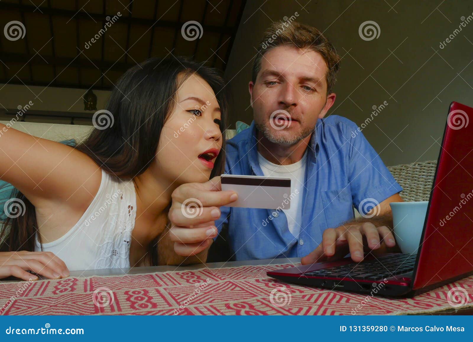 young-happy-excited-mixed-ethnicity-couple-asian-chinese-woman-white-man-internet-banking-online-shopping-cr-credit-card-131359280.jpg
