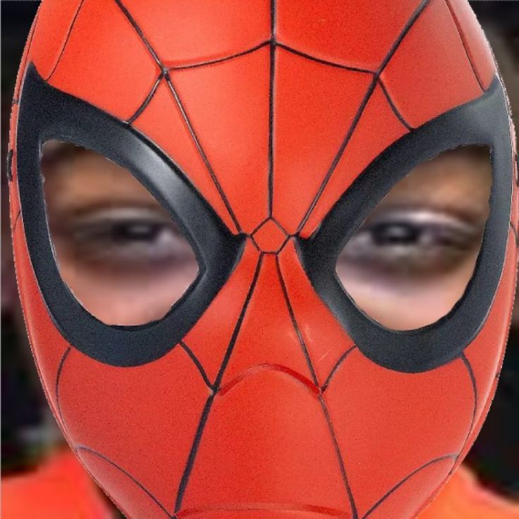 This may contain: a close up of a person wearing a spider man mask