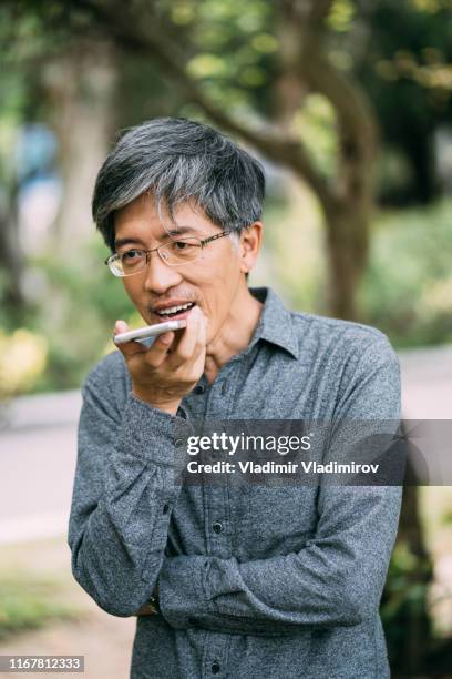 asian-man-talking-on-smart-phone-in-park.jpg