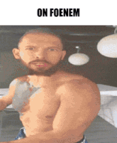 a shirtless man with a beard is standing in front of a sign that says  on foenem 