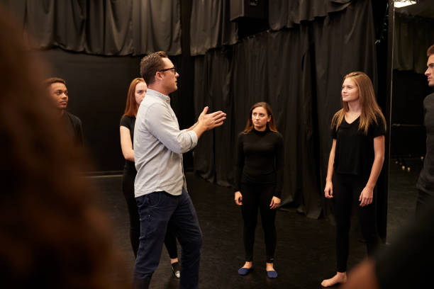 teacher-with-male-and-female-drama-students-at-performing-arts-school-in-studio-improvisation.jpg