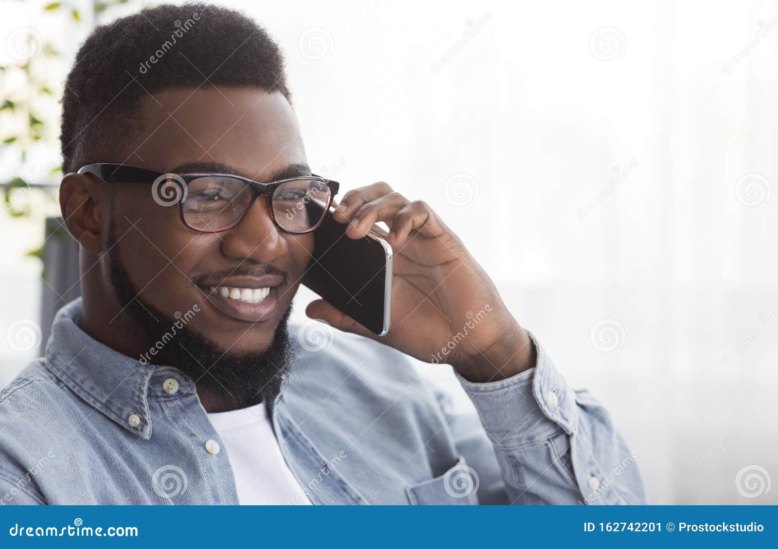 portrait-handsome-black-guy-glasses-talking-cellphone-touch-african-american-man-somebody-copy-space-162742201.jpg