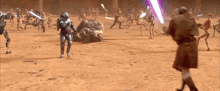 a group of soldiers are fighting each other in a field while a man is holding a lightsaber .