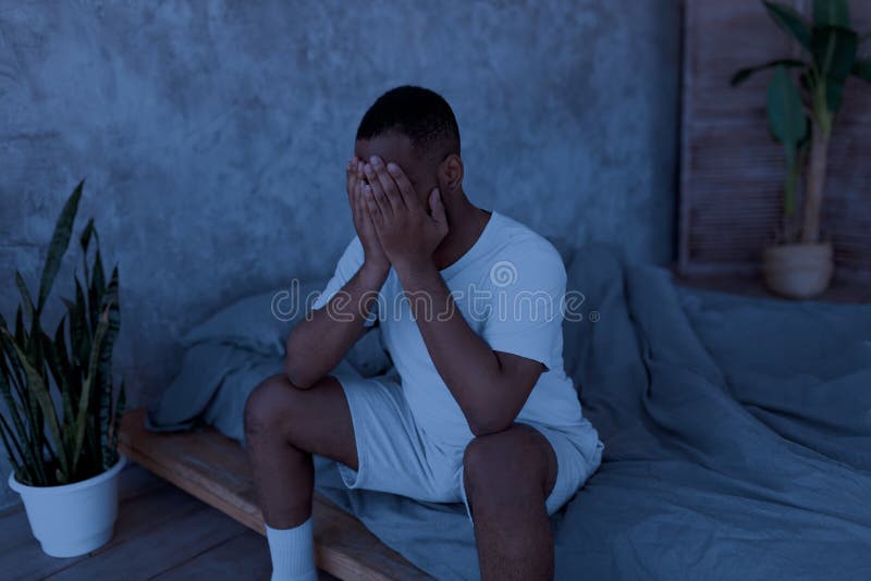 black-man-suffering-insomnia-sitting-bed-despair-insomnia-concept-portrait-depressed-young-black-guy-sitting-bed-234100887.jpg