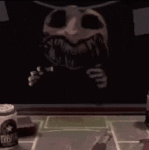 a skeleton is sitting at a table with a bottle of beer in front of it .