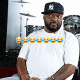 a man wearing a ny hat and a white shirt