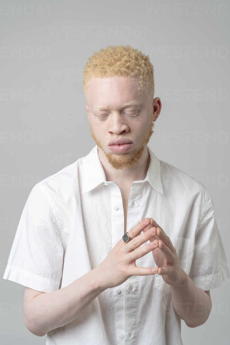 studio-portrait-of-albino-man-in-white-shirt-with-eyes-closed-ISF24919.jpg