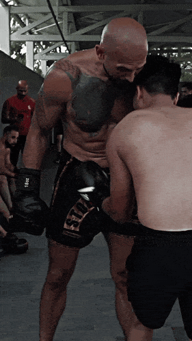 a man with a tattoo on his chest wears a pair of boxing gloves that say ' siu ' on it