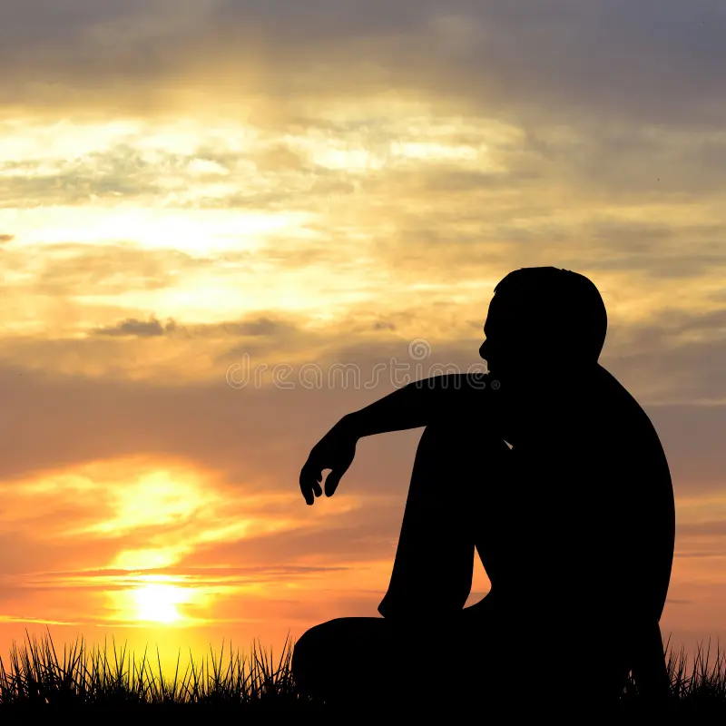 silhouette-man-sitting-watching-sunrise-119739384.webp