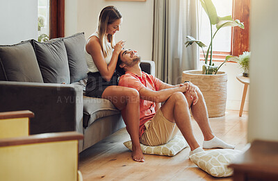 2475618-loving-young-caucasian-couple-sitting-together-at-home-spending-time-and-happy-to-be-together.-happy-young-woman-sitting-on-couch-while-her-boyfriend-sits-between-her-legs-as-she-plays-with-his-hair-fit_400_400.jpg