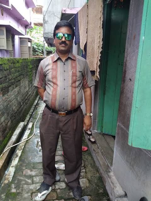 This may contain: a man standing in an alley way with sunglasses on