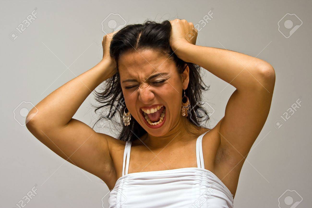 3151088-a-young-beautiful-latina-woman-screeming-of-frustration-and-pulling-her-hair-with-both-hands-wearing.jpg