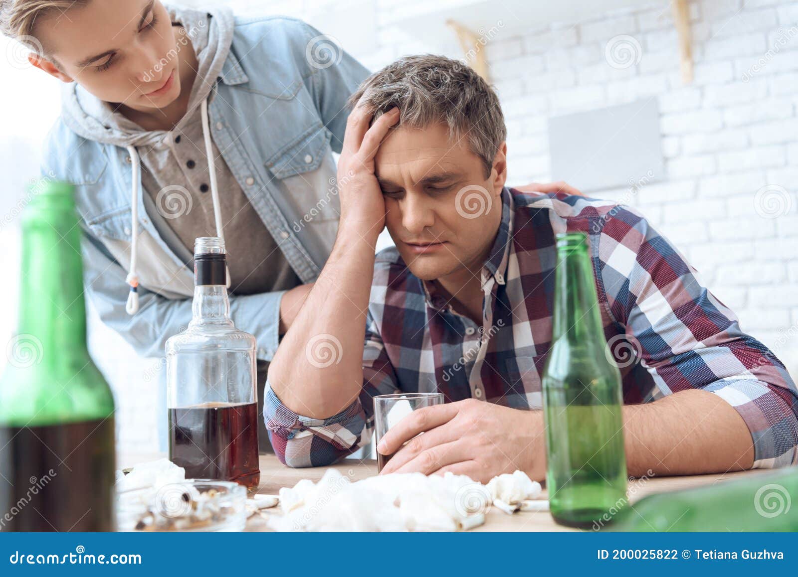 son-went-to-his-father-who-drinks-alcohol-table-alcoholic-man-sits-holds-glass-200025822.jpg