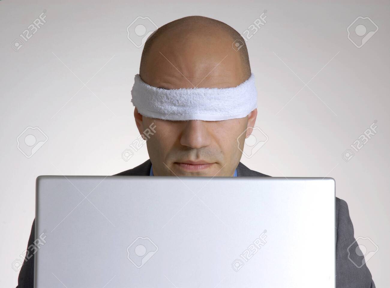 58443780-blindfolded-bald-man-using-a-computer.jpg