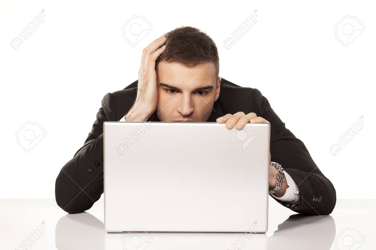 18656511-young-businessman-staring-helplessly-at-his-laptop.jpg