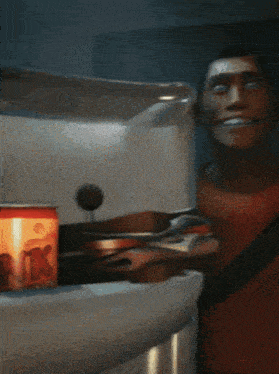 a man with a bandage on his forehead is smiling in front of a can of soda