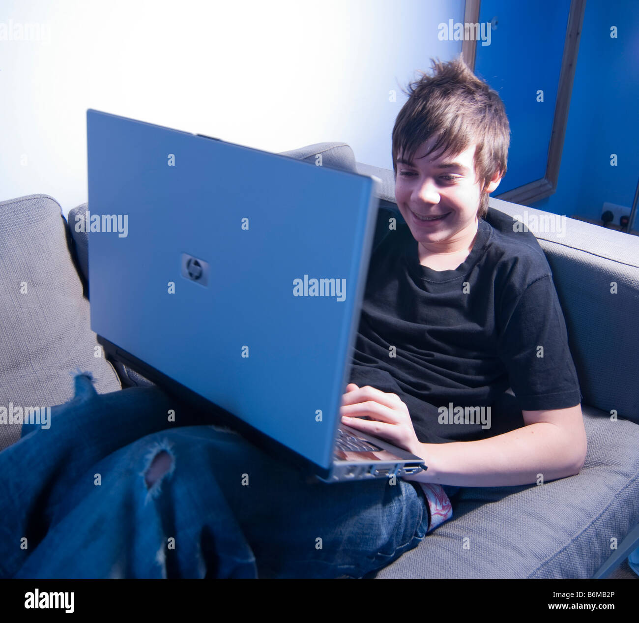 13-year-old-boy-teenager-with-laptop-computer-B6MB2P.jpg