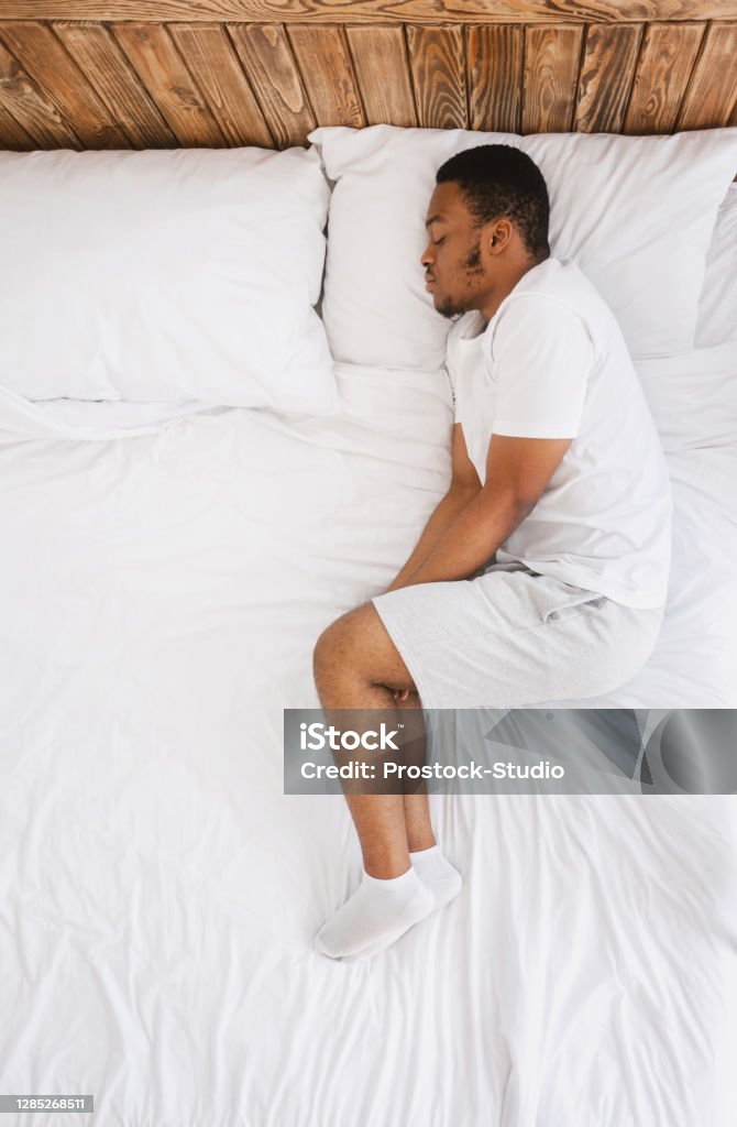 african-american-guy-sleeping-lying-in-bed-at-home-top-view.jpg