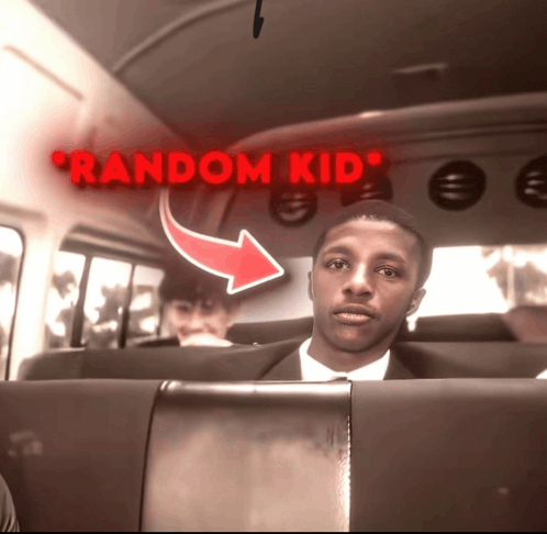 a man in a suit sits in the back of a bus under a red sign that says random kid