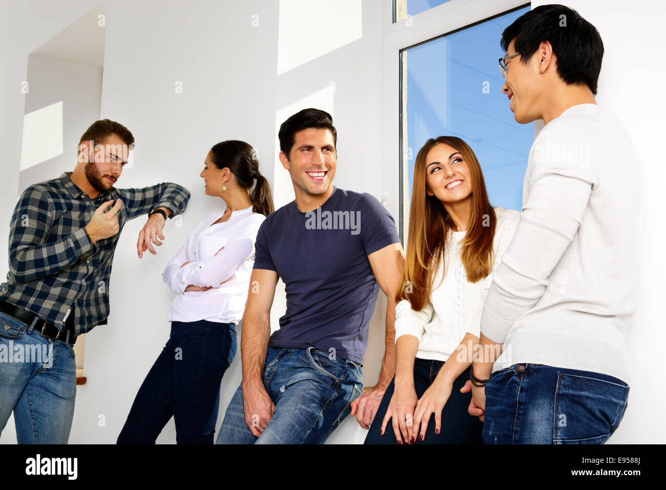 portrait-of-a-happy-group-of-people-talking-in-hallway-E9588J.jpg