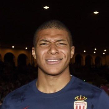 This may contain: a soccer player is posing for a photo in front of an audience at a sporting event
