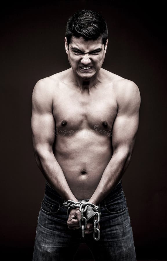 chained-man-hands-angry-shirtless-67704982.jpg