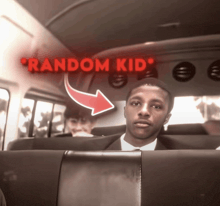 a man in a suit sits in the back seat of a bus with a red arrow pointing to random kid