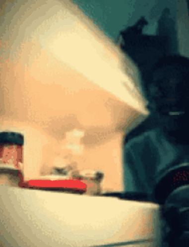 a jar of strawberry jam sits on a shelf