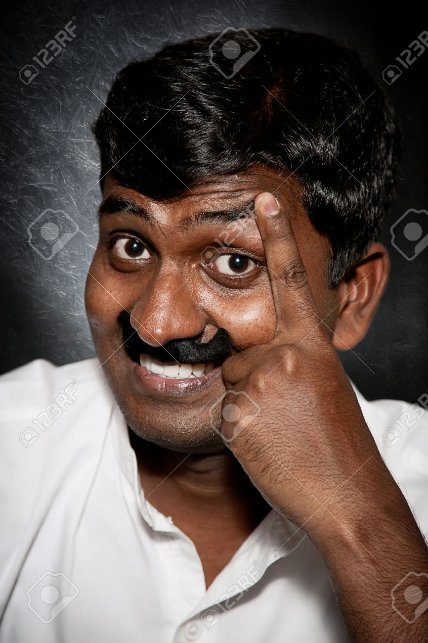 9265240-handsome-indian-man-with-moustache-and-raise-eyebrow-smiling-and-looking-at-camera-close-up.jpg