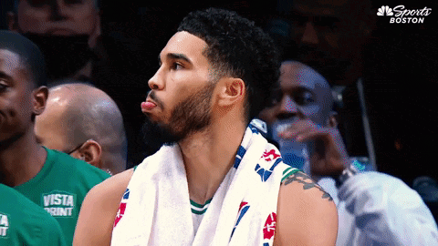 a basketball player with a towel around his neck is wearing a green shirt that says vista print