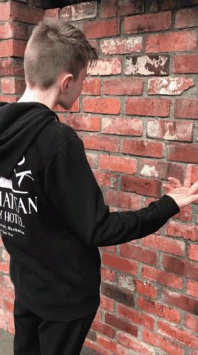 a boy wearing a black hoodie that says natan on it
