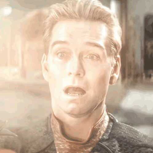 a close up of a man making a surprised face