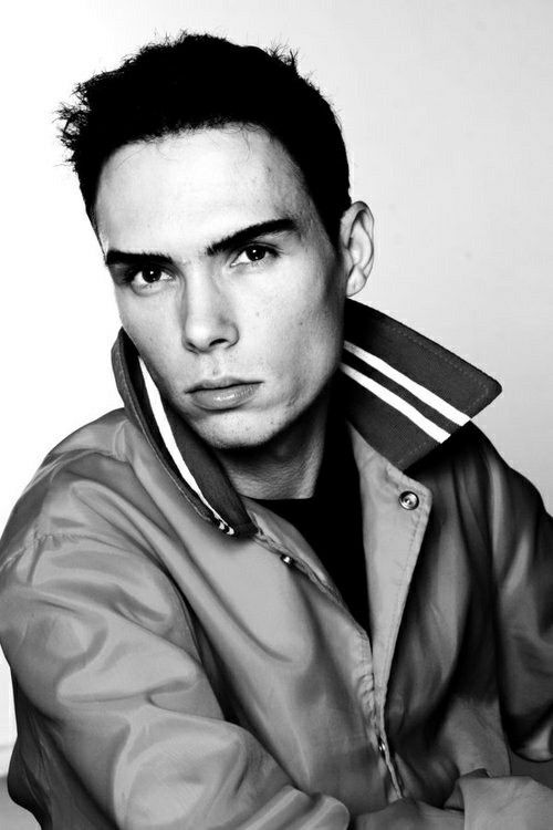This may contain: a black and white photo of a young man