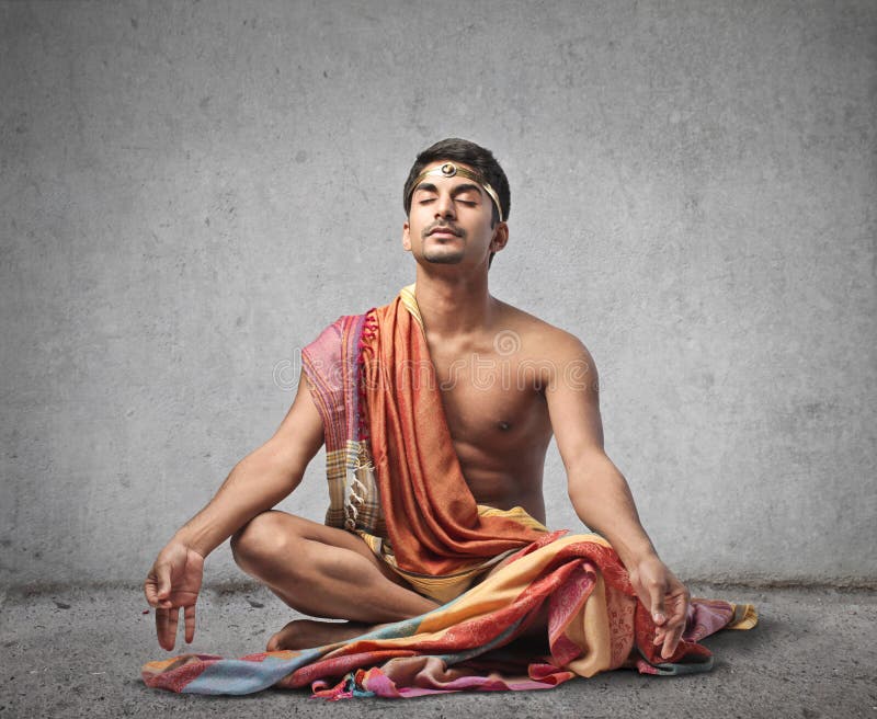 young-man-meditating-rock-wearing-indian-cloths-37028474.jpg