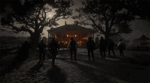 a group of people are walking in front of a large house at night .
