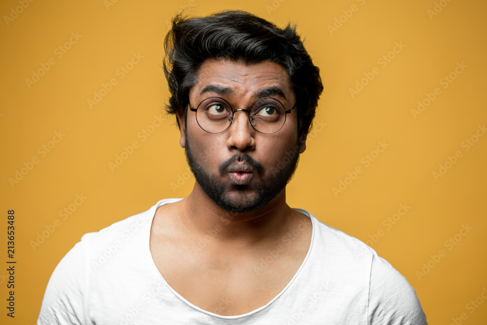 Indian good-looking man with funny facial expression trying to whistle.  ignore people Stock Photo | Adobe Stock