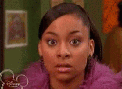 a close up of a woman 's face with a surprised look on it .