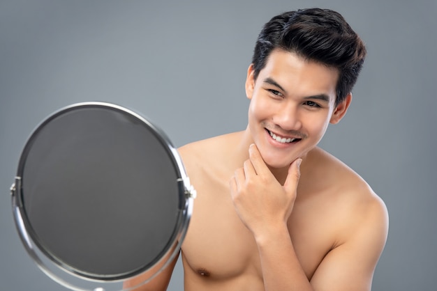 asian-male-model-confidently-looking-himself-mirror_8087-2075.jpg