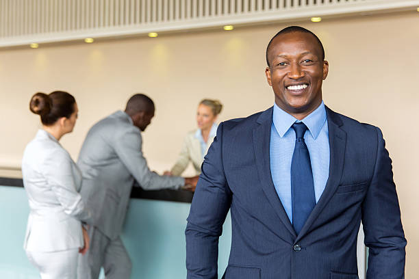 african-businessman-standing-at-hotel-reception.jpg