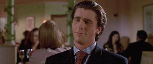a man wearing a suit and tie is making a funny face