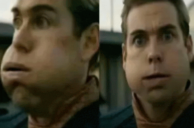 a close up of a man 's face with a huge chin and a very large mouth .