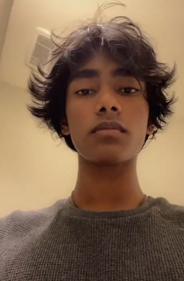 This may contain: a young man is taking a selfie in front of the mirror with his hair blown back