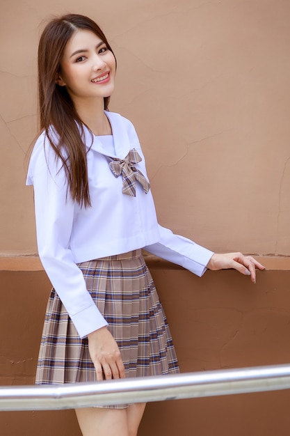 cute-young-girl-wearing-japanese-korean-style-schoolgirl-uniform-pose-camera-with-fun-happy-front-school-building_102814-2936.jpg